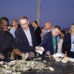 Corporate clients eating oysters on The Yorktown